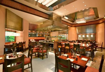 a dining room with tables and chairs in a restaurant at Grand Hyatt Residence in Dubai