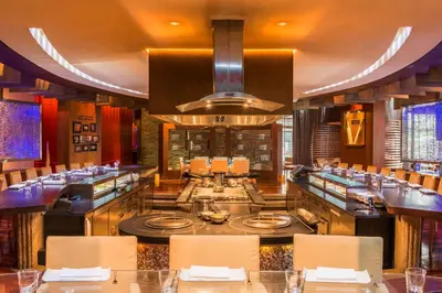 a restaurant with a bar with tables and chairs at Grand Hyatt Residence in Dubai