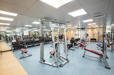 a gym with several rows of treadmills and machines at City Premiere Hotel Apartments - Dubai in Dubai
