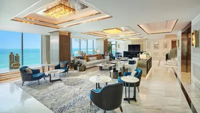 a hotel lobby with tables and chairs and the ocean at Mandarin Oriental Jumeira, Dubai in Dubai