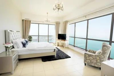 a bedroom with a bed and a couch and a chair at Luxury Casa - Grand Sea View Apartment JBR Beach 2BR in Dubai