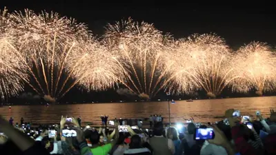 a crowd of people taking pictures of fireworks at Luxury Casa - Grand Sea View Apartment JBR Beach 2BR in Dubai