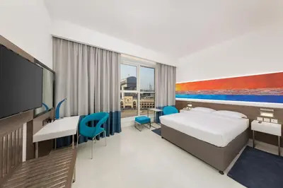 a hotel room with a bed and a flat screen tv at Citymax Hotel Al Barsha in Dubai
