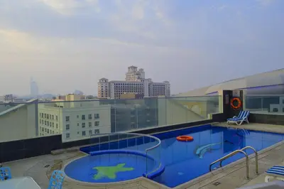 a swimming pool on the roof of a building at Tulip Al Barsha Hotel Apartment in Dubai