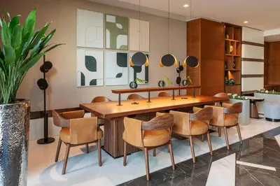 a dining room with a wooden table and chairs at Sheraton The Walk, Dubai in Dubai