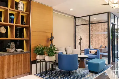 a lobby with blue chairs and a table at Sheraton The Walk, Dubai in Dubai