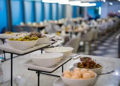 a buffet line with bowls and plates of food at Millennium Atria Business Bay in Dubai