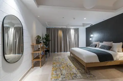 a bedroom with a large bed and a mirror at EDEN'S Homes & Villas - KG Tower in Dubai