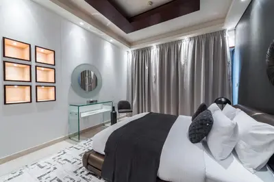 a bedroom with a bed and a desk at EDEN'S Homes & Villas - KG Tower in Dubai
