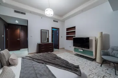 a living room with a flat screen tv and a couch at EDEN'S Homes & Villas - KG Tower in Dubai