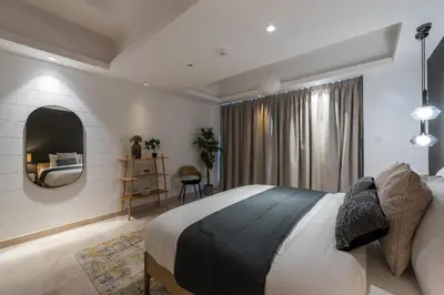 a bedroom with a large bed and a mirror at EDEN'S Homes & Villas - KG Tower in Dubai