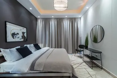 a bedroom with a large bed and a mirror at EDEN'S Homes & Villas - KG Tower in Dubai