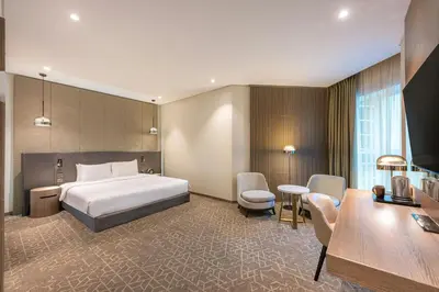 a hotel room with a bed and a desk at Courtyard by Marriott Dubai, Al Barsha in Dubai