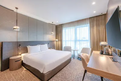 a hotel room with a bed and a desk at Courtyard by Marriott Dubai, Al Barsha in Dubai