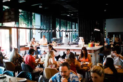 a group of people sitting in a restaurant at Studio One Hotel in Dubai