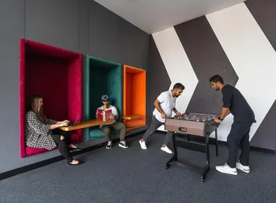 a group of people playing chess in a room at Studio One Hotel in Dubai