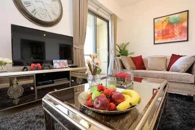a living room with a bowl of fruit on a table at Luxury Casa - Marvel Sea View Apartment JBR Beach 2BR in Dubai