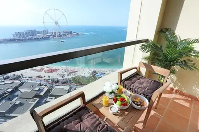 a balcony with a table with a view of the ocean at Luxury Casa - Marvel Sea View Apartment JBR Beach 2BR in Dubai