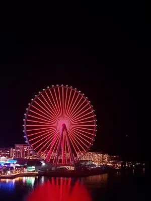 a large ferris wheel lit up at night at Luxury Casa - Marvel Sea View Apartment JBR Beach 2BR in Dubai