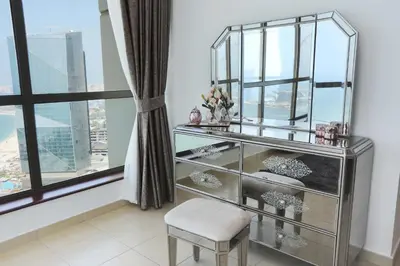 a glass cabinet with a chair in a room with a window at Luxury Casa - Marvel Sea View Apartment JBR Beach 2BR in Dubai