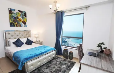 a bedroom with a bed and a large window at Luxury Casa - Marvel Sea View Apartment JBR Beach 2BR in Dubai