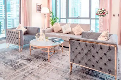a living room with a couch and a table at Ultimate Stay 2BR: Burj Khalifa and fountain view in Dubai