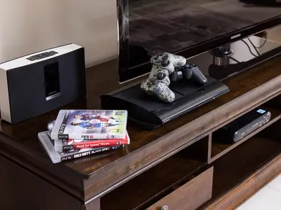 a desk with a tv and a book and a stuffed animal at Ultimate Stay 2BR: Burj Khalifa and fountain view in Dubai