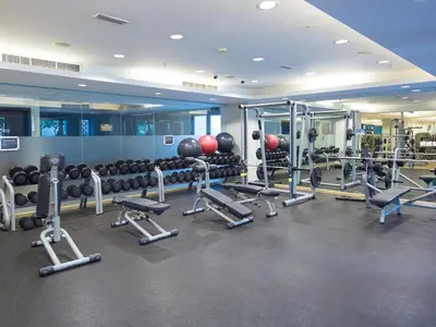 a gym with a lot of equipment and weights at Ultimate Stay 2BR: Burj Khalifa and fountain view in Dubai