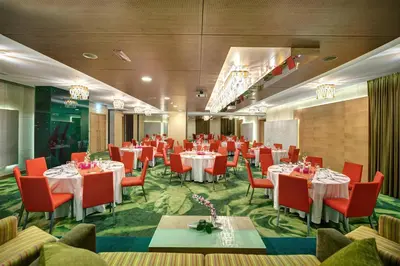 a banquet room with tables and chairs in a room with at Al Khoory Executive Hotel, Al Wasl in Dubai