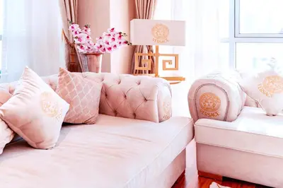a pink living room with a couch and pillows at Elite Royal Apartment - Burj Residences T5 | VIP in Dubai