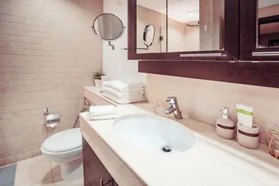 a bathroom with a sink and a toilet and a mirror at Elite Royal Apartment - Burj Residences T5 | VIP in Dubai