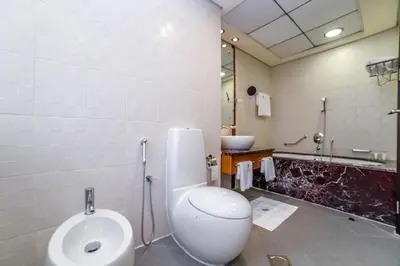 a bathroom with a toilet and a sink at Royal Beach Residence in Dubai