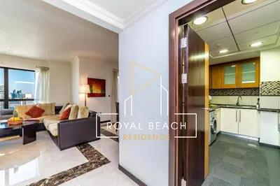a view of a living room and kitchen in a apartment at Royal Beach Residence in Dubai