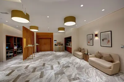 a large lobby with couches and a table at The S Hotel Al Barsha in Dubai