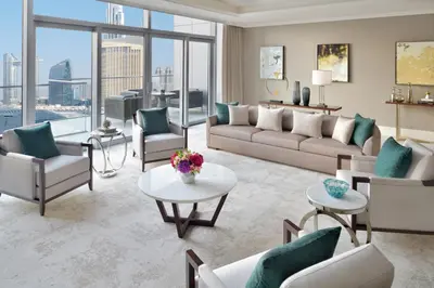 a living room with a couch and chairs and a table at Address Dubai Mall in Dubai
