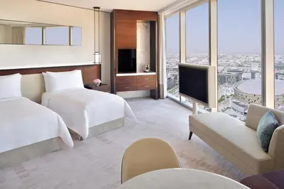 a hotel room with two beds and a tv at Address Sky View, Downtown Dubai in Dubai