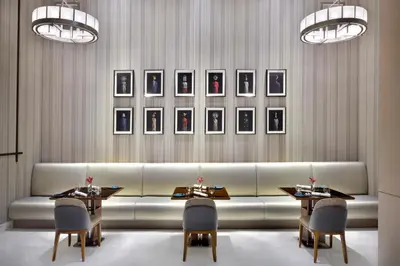 a living room with a couch and two tables and pictures at Address Sky View, Downtown Dubai in Dubai