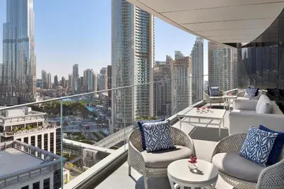 a balcony with chairs and tables and a view of a city at Address Sky View, Downtown Dubai in Dubai