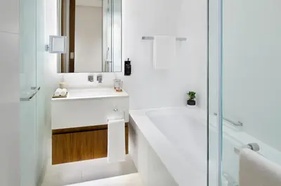 a bathroom with a tub and a sink and a shower at Vida Emirates Hills in Dubai
