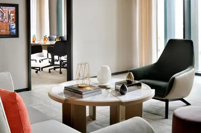 a living room with a chair and a table at Vida Emirates Hills in Dubai