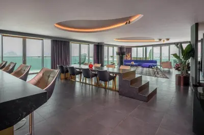 a hotel lobby with a dining area and tables and chairs at W Dubai - The Palm in Dubai