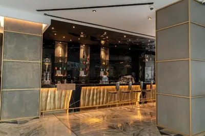a bar with stools in a restaurant at W Dubai - The Palm in Dubai