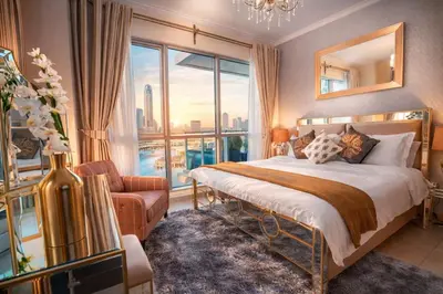 a bedroom with a bed and a large window at Elite Royal Apartment | Burj Residences Tower 5 | Gold in Dubai