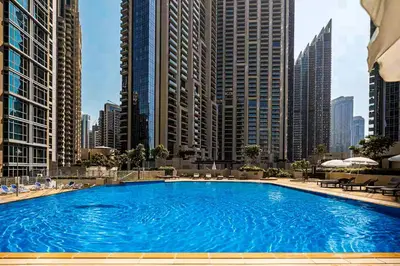 a large swimming pool in a city with tall buildings at Elite Royal Apartment | Burj Residences Tower 5 | Gold in Dubai