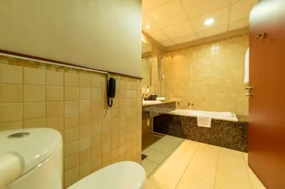 a bathroom with a toilet and a sink at SUHA JBR Hotel Apartments in Dubai