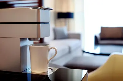 a white coffee cup sitting on top of a table at JW Marriott Marquis Hotel Dubai in Dubai