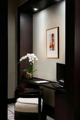 a office with a desk with a computer and a chair at JW Marriott Marquis Hotel Dubai in Dubai