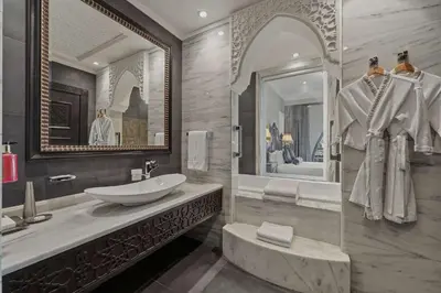 a bathroom with a sink and a large mirror at Zabeel Saray Royal Residences Lagoon Villa in Dubai