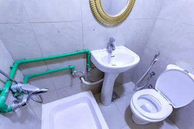 a bathroom with a sink and a toilet and a mirror at Budget Rooms With Private Bathroom for 'girls' only in Dubai, Marina in Dubai
