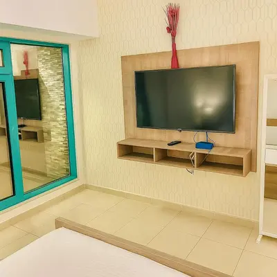 a living room with a flat screen tv on a wall at Classy Studios for Ladies in Dubai, Marina فتيات فقط in Dubai